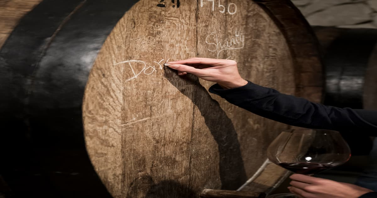 A whisky cask resting in a distillery warehouse